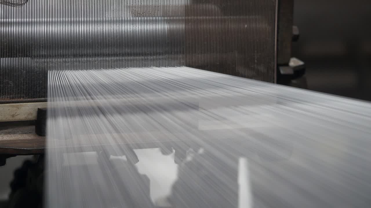 Close-up view of a weaving machine in operation