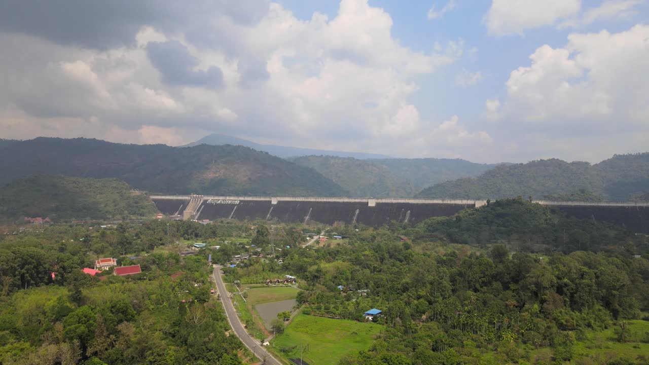 Aerial Drone Shot with Mountainous Background and Scenic Landscape Revealing a Thai Reservoir in Nakhon Nayok, Thailand.