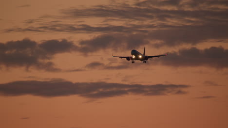 airplane landing at sunset