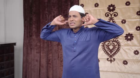 Indischer-Muslim-Wird-Durch-Laute-Geräusche-Gestört
