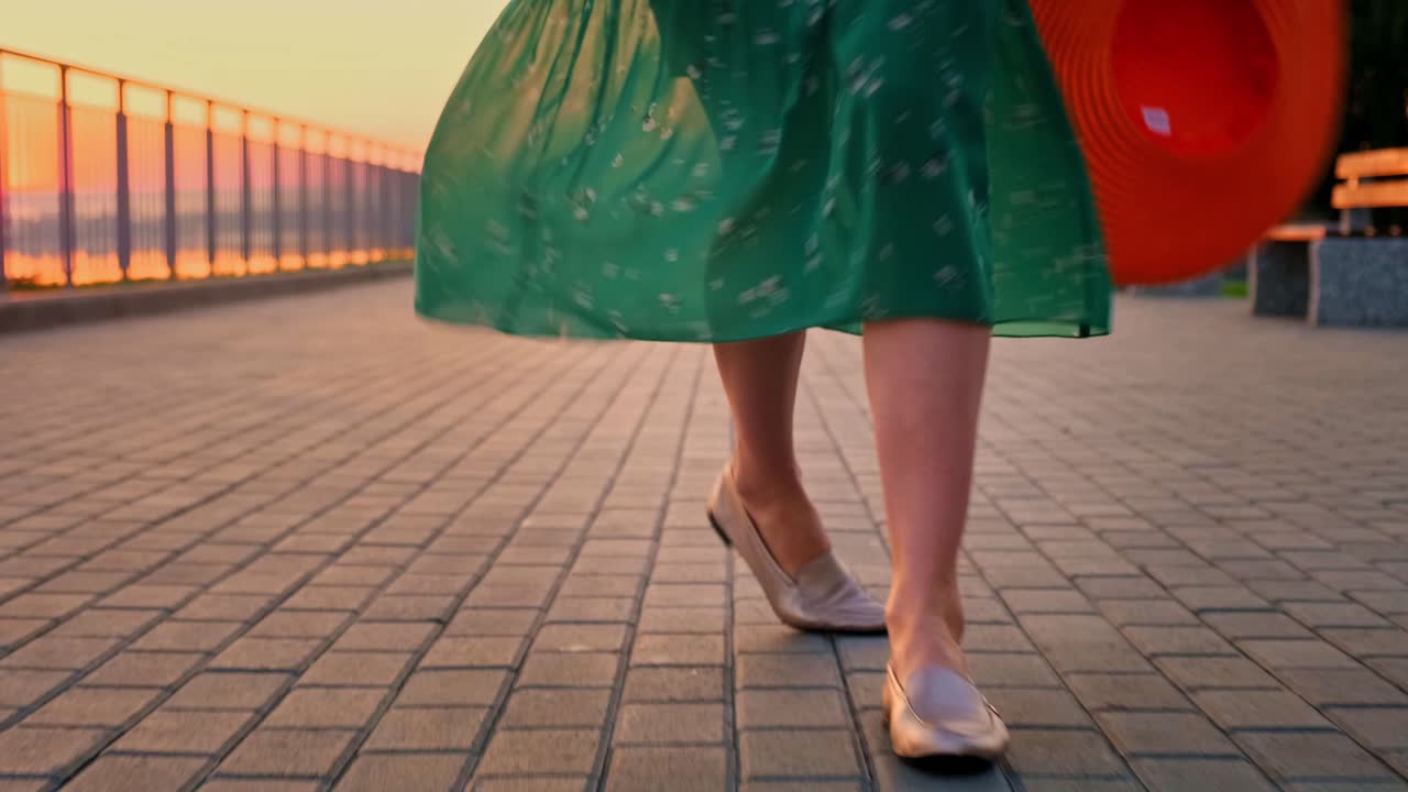 A Vibrant Evening Walk: Capturing the Joy of Movement and Nature's Beauty in a Scenic Sunset Stroll with a Beautiful Dress and a Stylish Hat