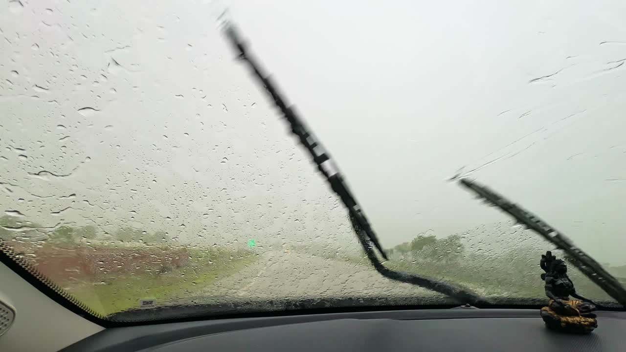 Pov shot of driving in the heavy rain with the wipers on