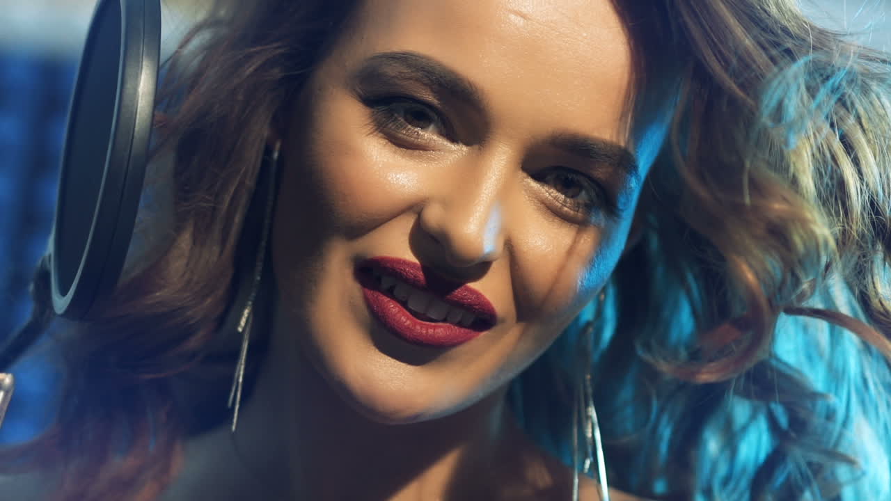 Woman singing in a recording studio. Female vocals. Professional recording studio.