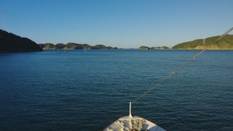 Bow-of-Ship-as-it-passes-Islands-of-Toba,-Mie,-on-Sunny-Day-in-Slow-Motion