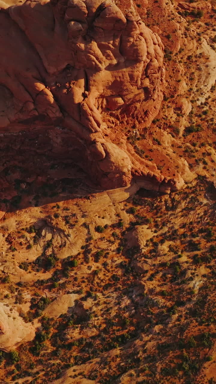 Rocky landscape of Arches National Park in Utah, United States. Unusual rounded canyons created by air erosion from bird's eye view. Vertical video