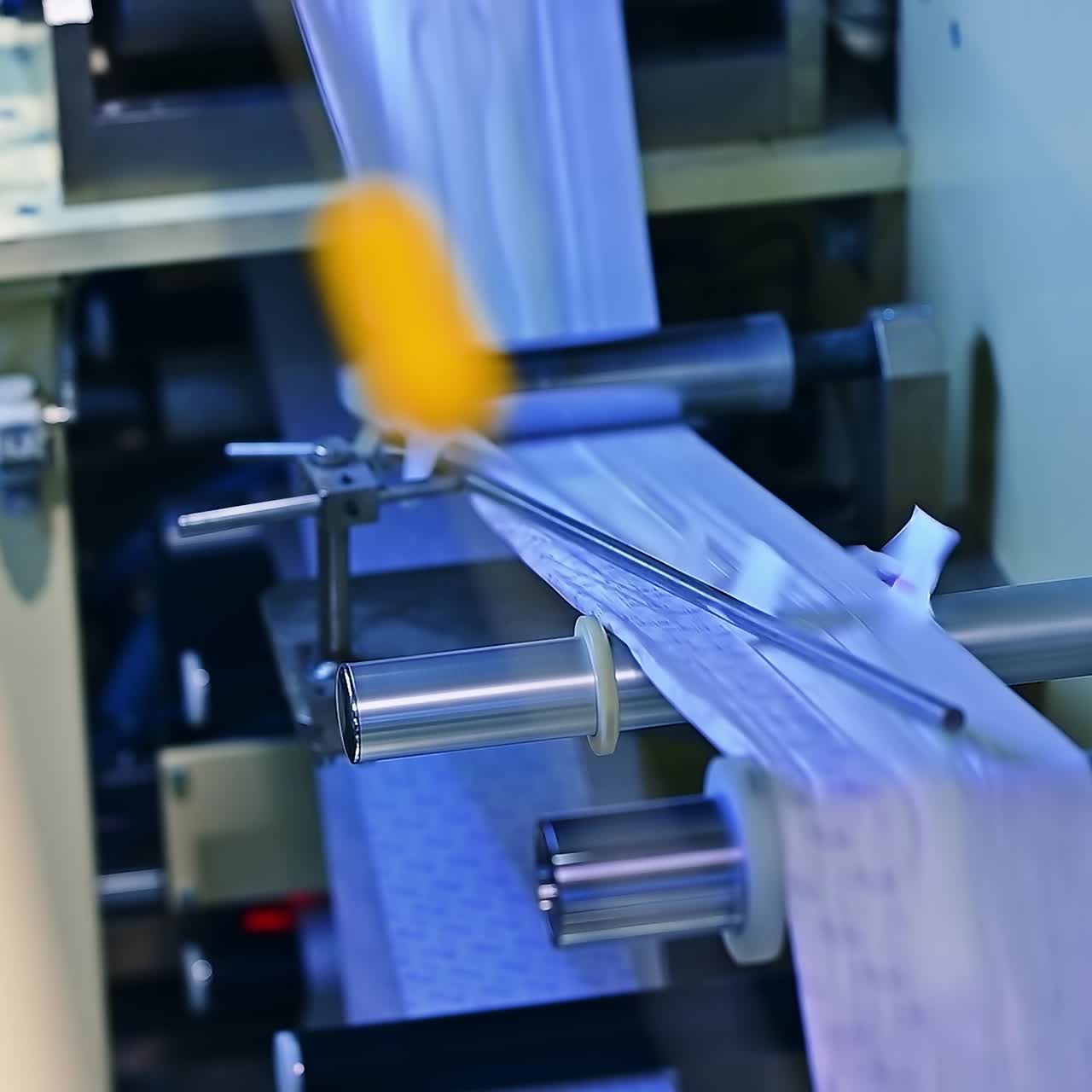 A large roll of cellulose producing diapers. Factory industrial making pampers