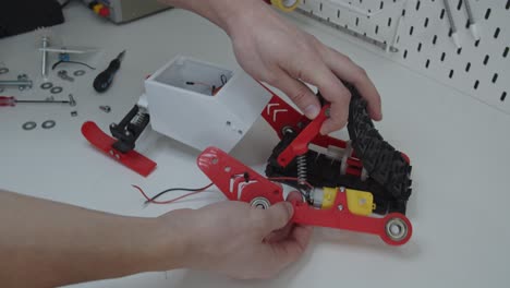 disassembling small remote controlled snowmobile toy