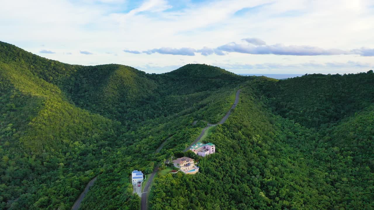 Aerial footage of St. Croix showcases elegant homes placed sparingly within the thick jungle, nestled on lush hillsides with wide island views and rugged Caribbean mountains rising in the distance