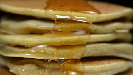 honey flowing down a stack of pancakes, perfect for breakfast along with some coffee or milk