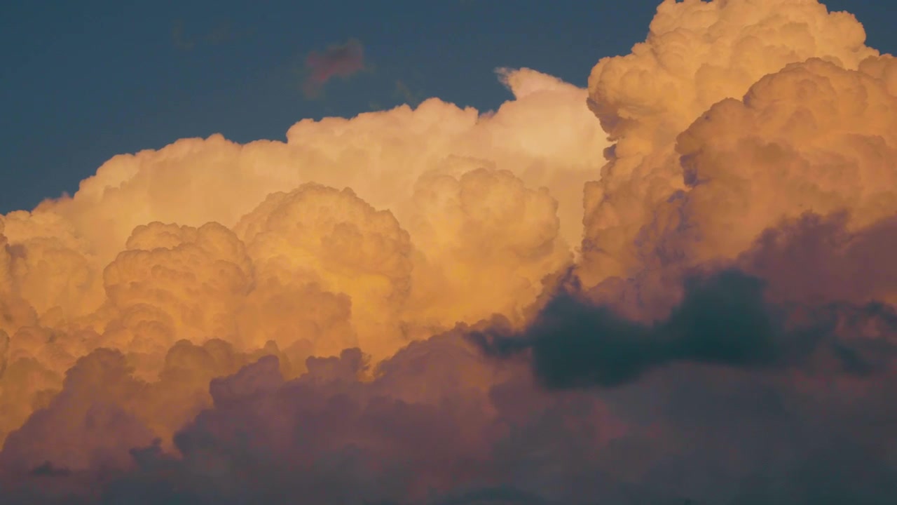 Panning shot of storm clouds at golden hour.