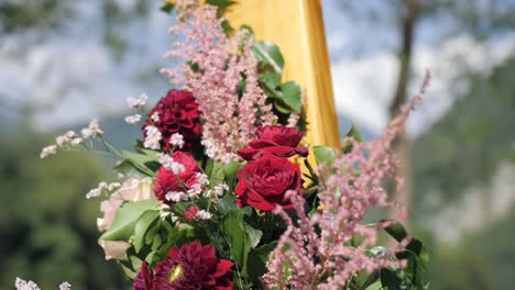 boho flower decoration detail on wedding arch, outdoor dolly closeup, sunny day