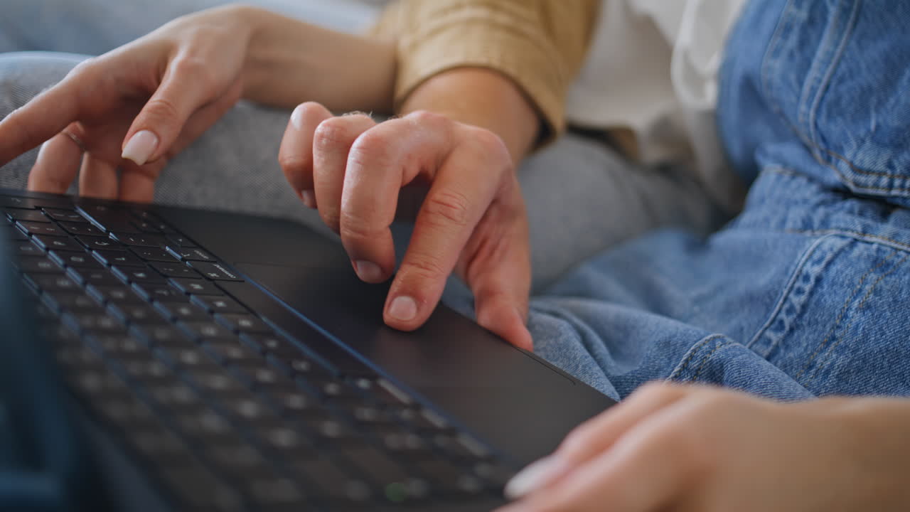 Couple hands using laptop together in apartment closeup. Spouses browsing
