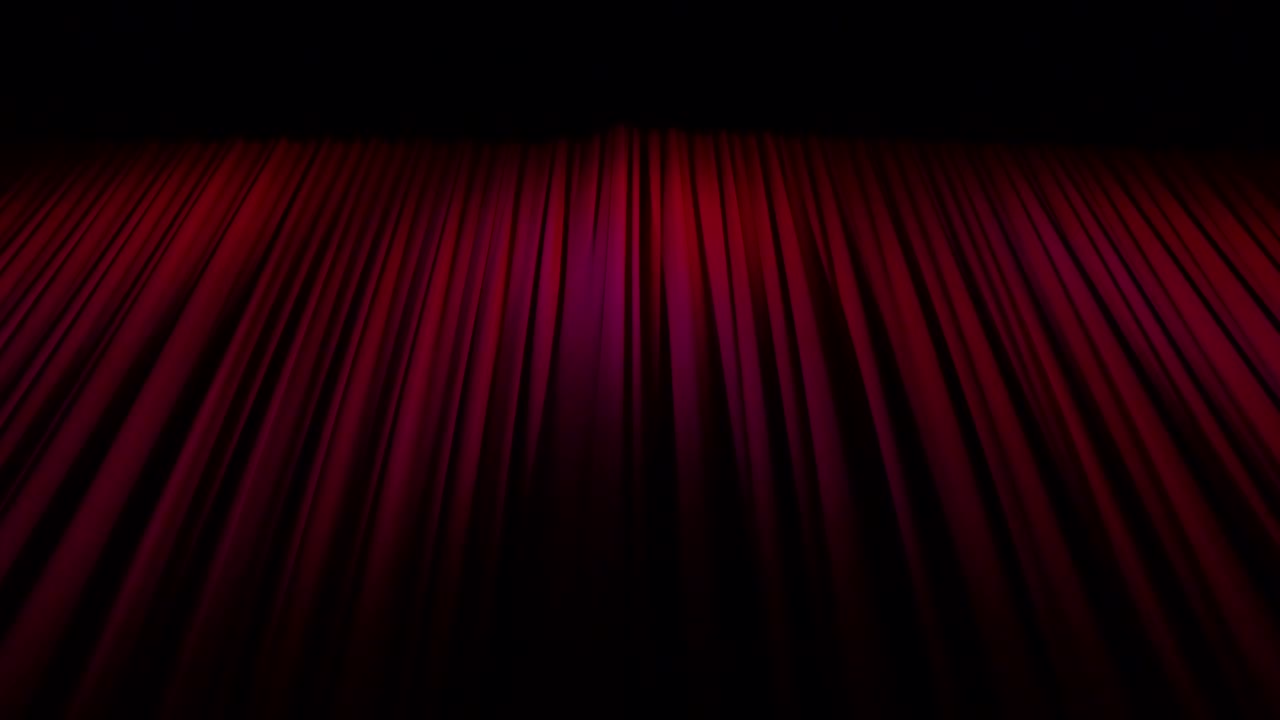 Looking up from stage height at deep red, heavy theatre curtains or main drape when closed