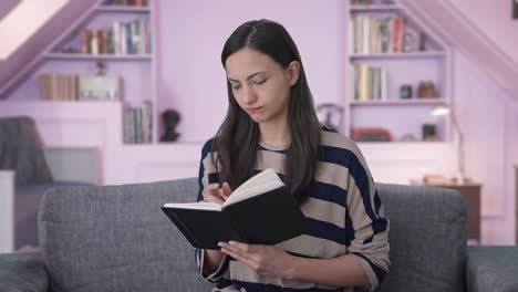 indian girl writing a book