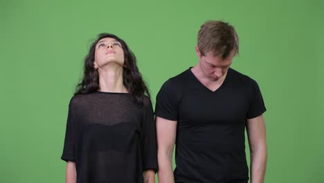 young couple looking in different directions together