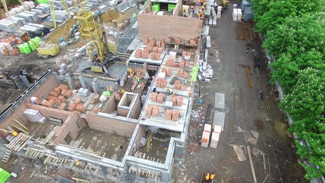 VINNITSA, UKRAINE - JUNE 2016: Aerial shot of the building construction site with cranes and industrial units
