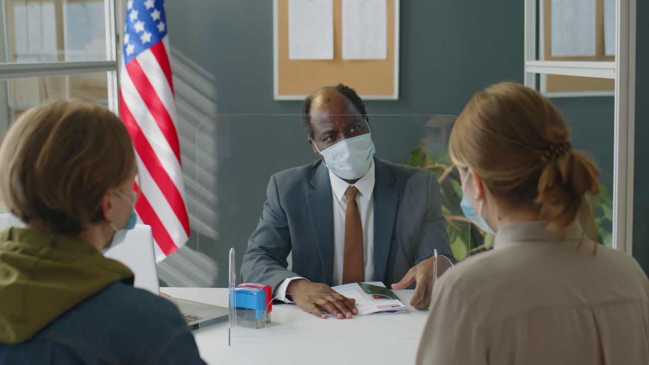 Meeting with Election Official Behind Protective Barrier