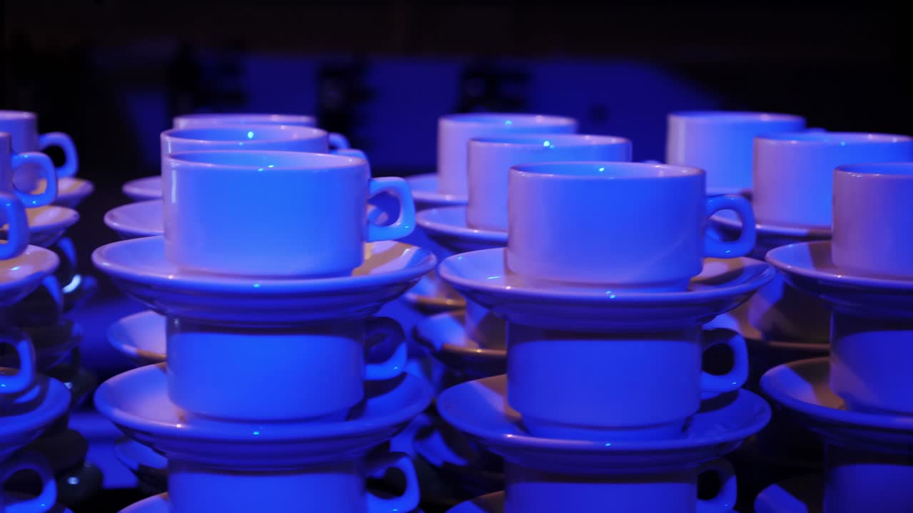 Stacked White Cups with Blue Light