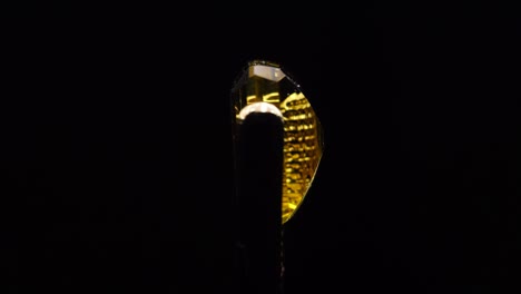 natural yellow citrine in the tweezer on the turning table