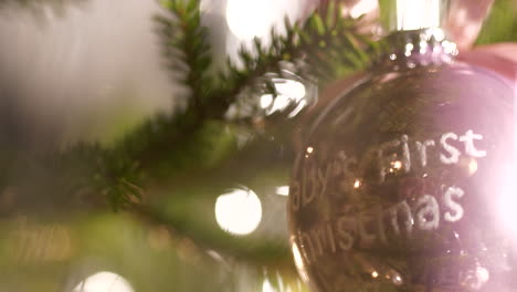 happy family celebrating newborn baby, christmas tree decoration