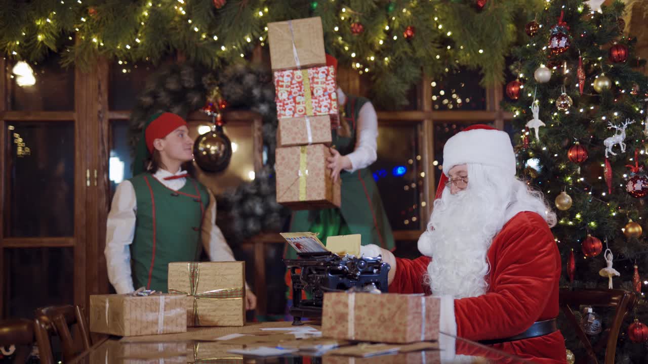 Santa Claus and elves with gift boxes. Santa Claus and elves in Christmas working