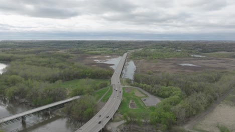 cars driving on freeway 101 over the minnesota valley national wildlife refuge near shakopee, minnesota, usa. - aerial shot