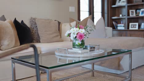 flowers-in-a-glass-vase-on-a-glass-table-in-the-living-room-of-a-modern-luxury-home