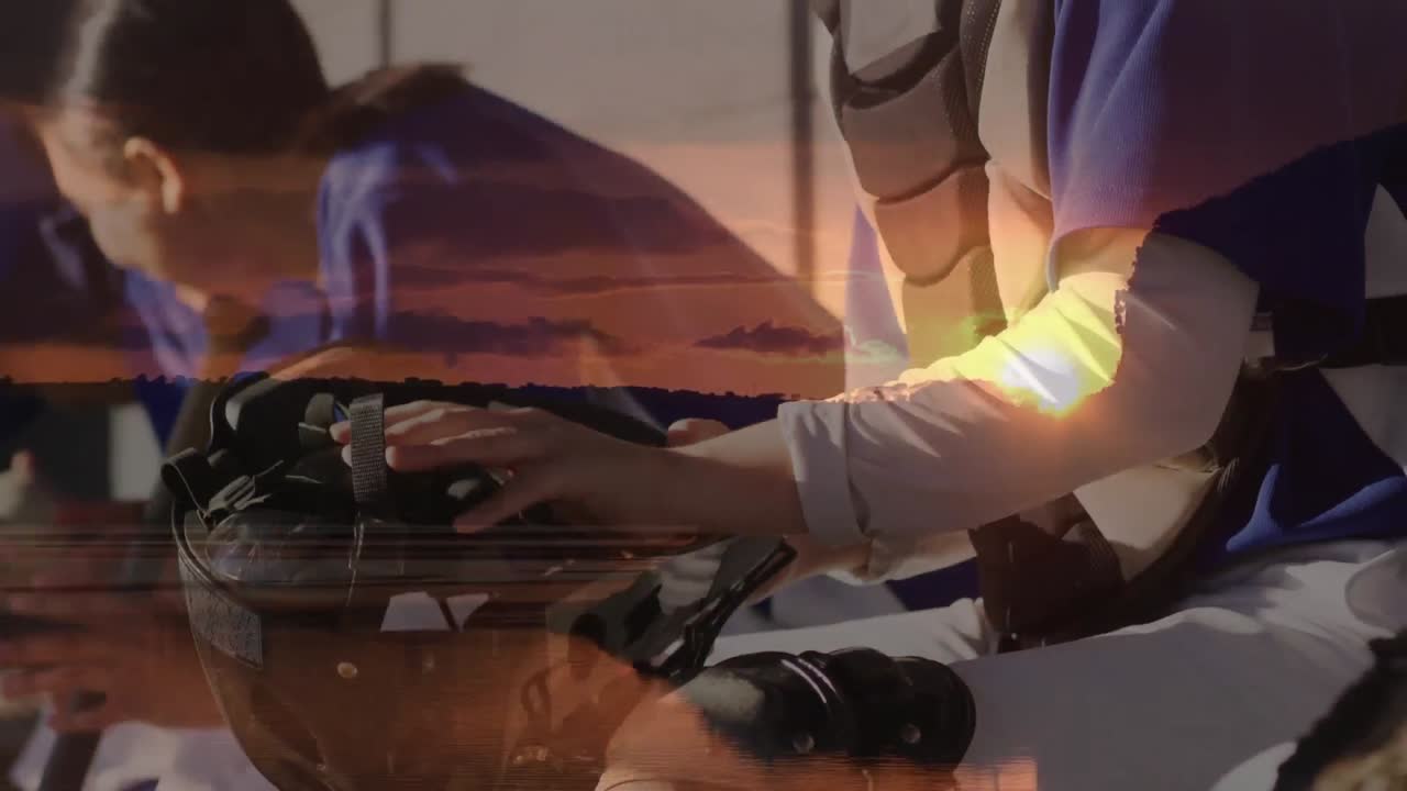 Animation of sunset over diverse male and female football team preparing for match