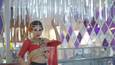 mysterious woman in traditional indian wedding lehenga posing with the city lights in the background