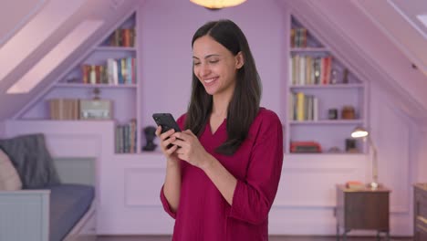 Happy-Indian-woman-chatting-with-someone