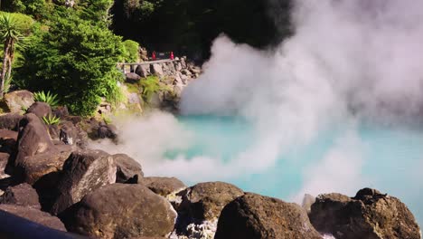 geothermal steam billows out of umi jigoku pool, beppu, oita, japan