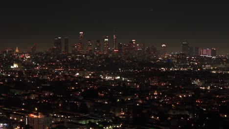 tilting up aerial dolly shot of the los angeles skyline at night in california. 4k