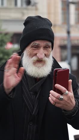 an old man taking a selfie on the street