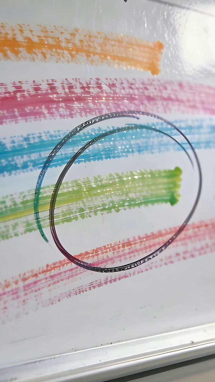 Vertical video: Shifting camera showing office board black rings over color strokes to center rings