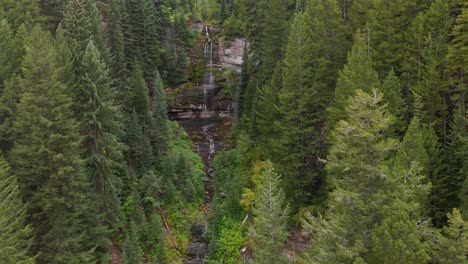 waterfall, water falling down rocky mountain in forest