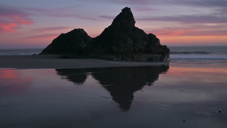 rock reflection in wet sand