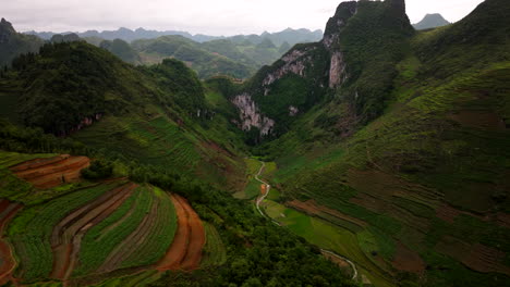 motorcycle route ha giang loop terraced rice fields and limestone mountains, drone shot