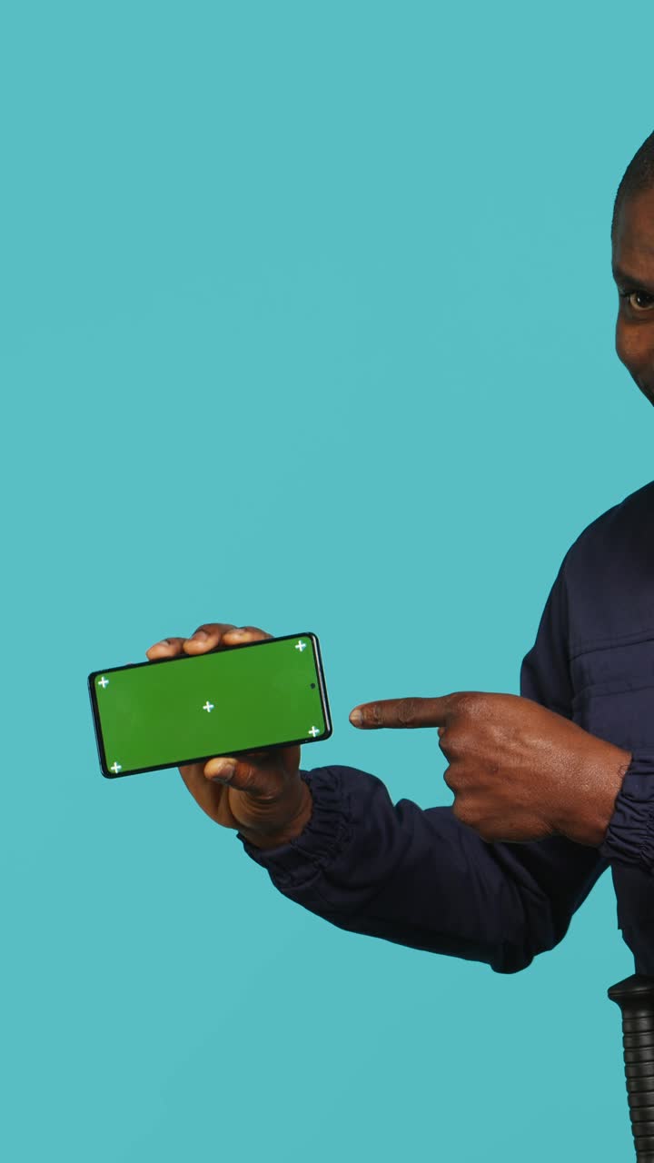 Hand Holding Horizontal Smartphone with Green Screen Display