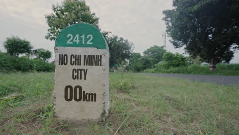 highway milestone showing distance of ho chi minh city