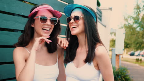 two women laughing outdoors