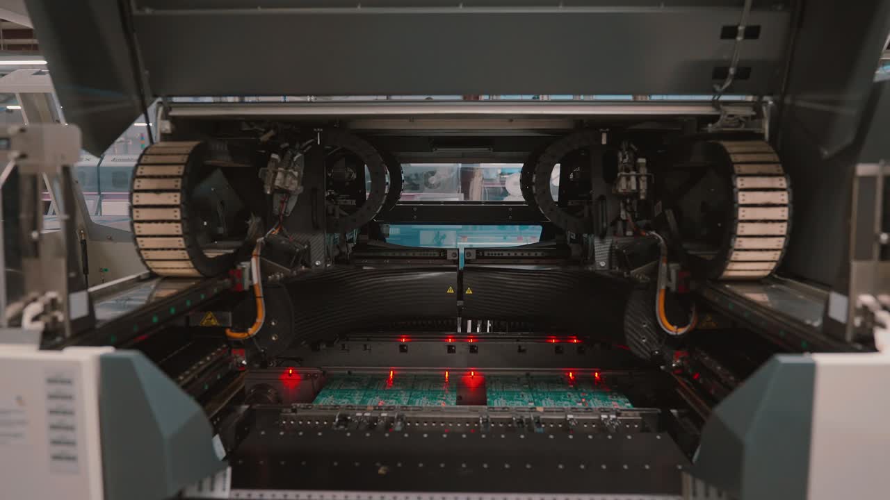 Precision electronics assembly in slow motion, showcasing machinery in detail