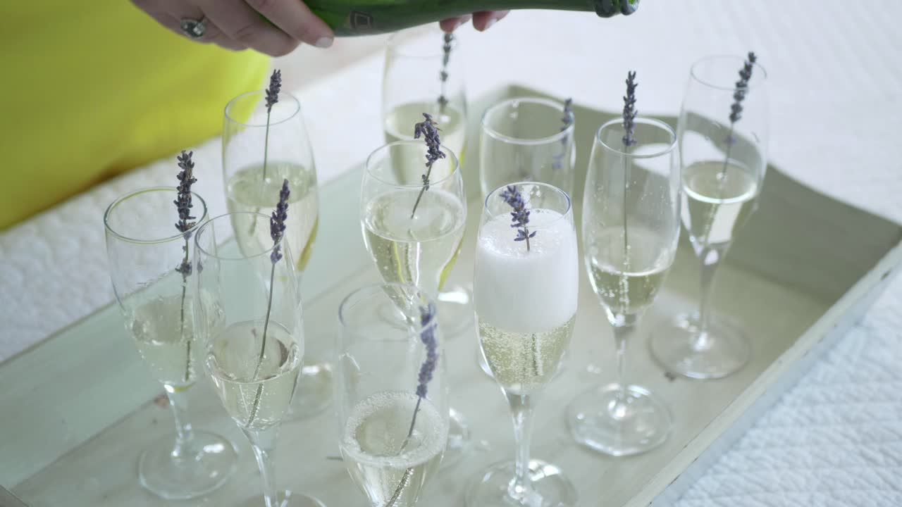 champagne pouring in beautiful glass with lavender decoration