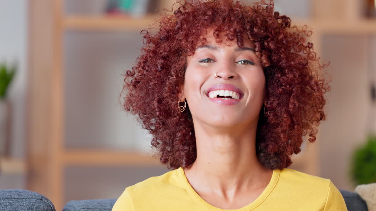 Giovane donna audace con un afro rosso riccio sorridente