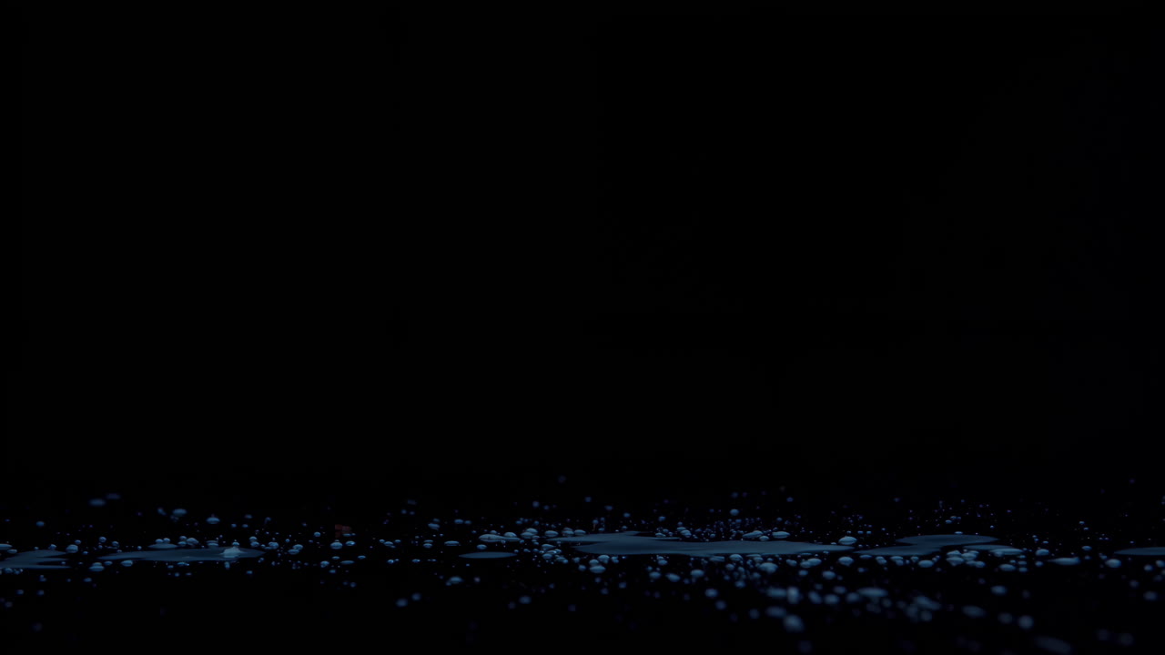 Coconut broken in slow motion on black background