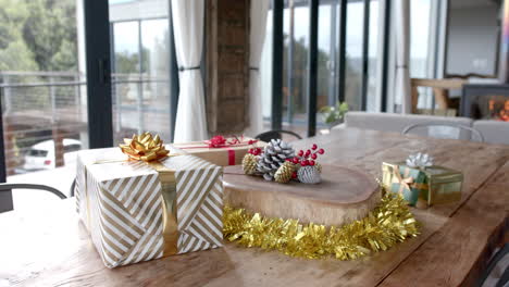 close up of presents and decorations on table in living room, slow motion