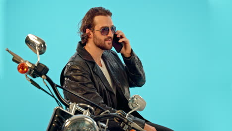 phone call, man and motorbike in studio on blue