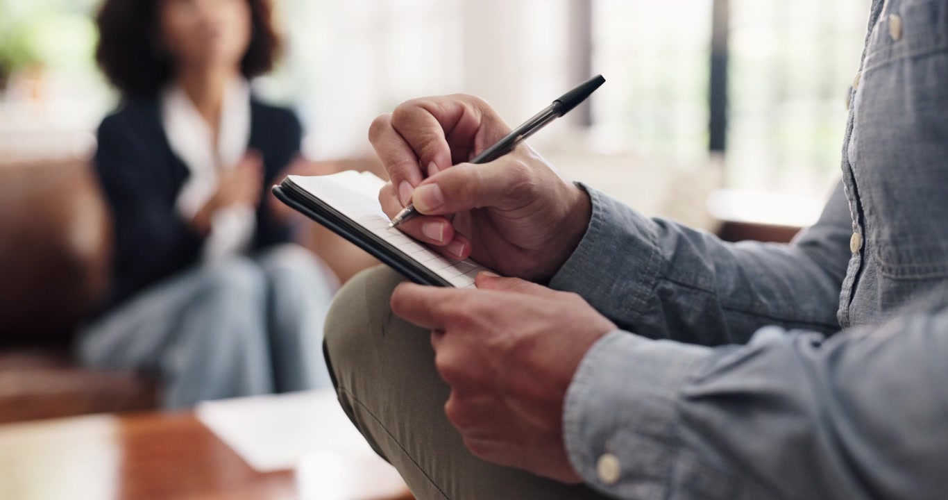 Therapist Taking Notes During Counseling Session