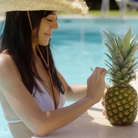 young woman sipping a pineapple cocktail