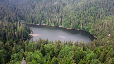 a beautiful mountain range with a lake in the middle the lake is surrounded by trees and the mounta a beautiful mountain range with a lake in the middle the lake is surrounded by trees and the mountains are covered in snow the sky is clear and the sun is shining