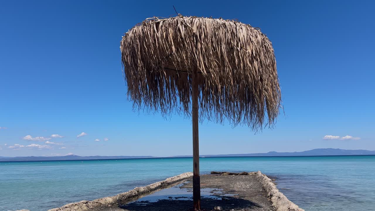 Stunning beach scene in Halkidiki, Greece, with elegant sunbeds facing the crystal-clear turquoise sea. A perfect summer escape in the heart of the Aegean.